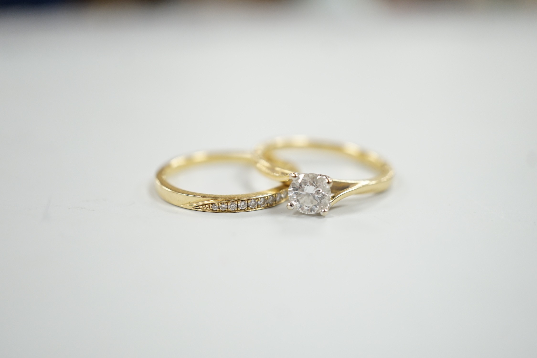 A modern Parkhouse 18ct gold wedding set, comprising a graduated ten stone diamond chip set half hoop band and an Isabella solitaire diamond ring, the latter with accompanying GIA report dated 4/12/2014, stating the ston